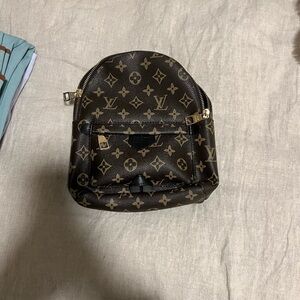 Brown and gold leather backpack